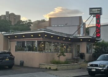 Tibbett Diner exterior at sunset with neon DINER sign, Bronx NYC