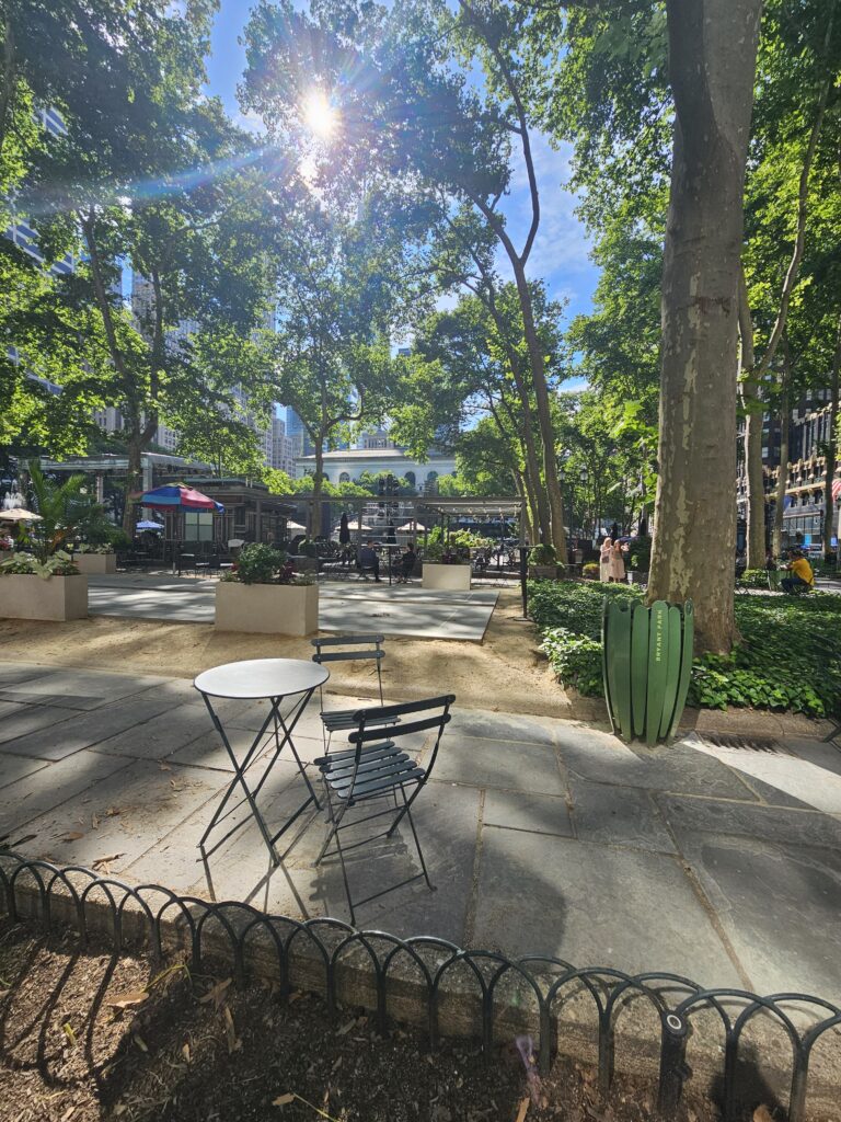 Bryant Park NYC Parisian chairs and tree canopy in Midtown Manhattan