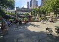 Bryant Park NYC fountain and main plaza with Parisian chairs and Manhattan skyline