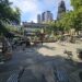 Bryant Park NYC fountain and main plaza with Parisian chairs and Manhattan skyline