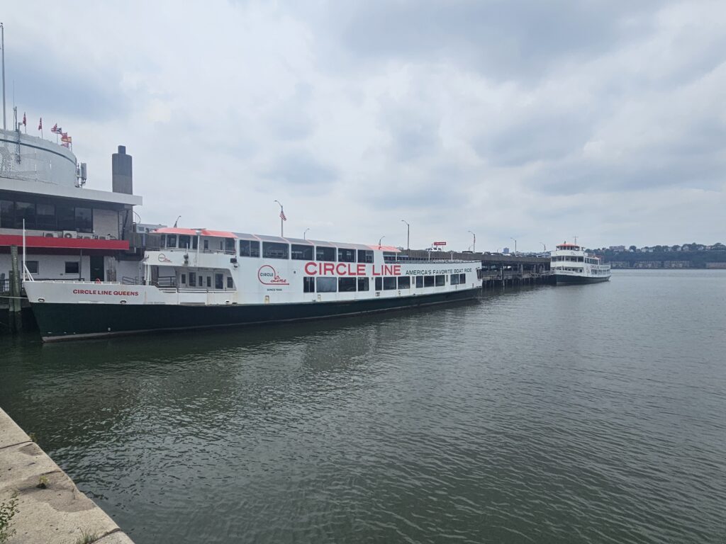 Circle Line sightseeing cruise boat on the Hudson River passing Manhattan landmarks