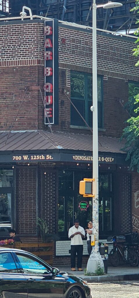 Dinosaur Bar-B-Que Harlem neon sign on brick building corner West 125th Street