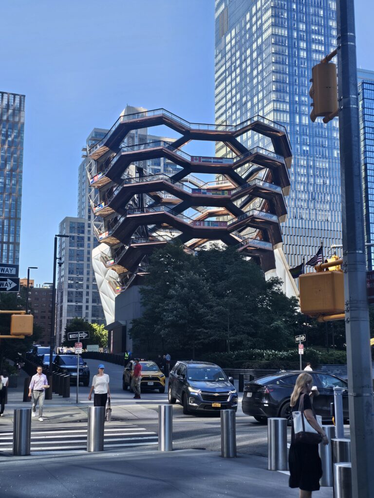 The Vessel Hudson Yards viewed from street level with Manhattan skyscrapers in background