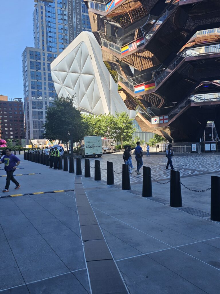The Vessel Hudson Yards side view with The Shed arts center visible and Van Leeuwen ice cream truck nearby