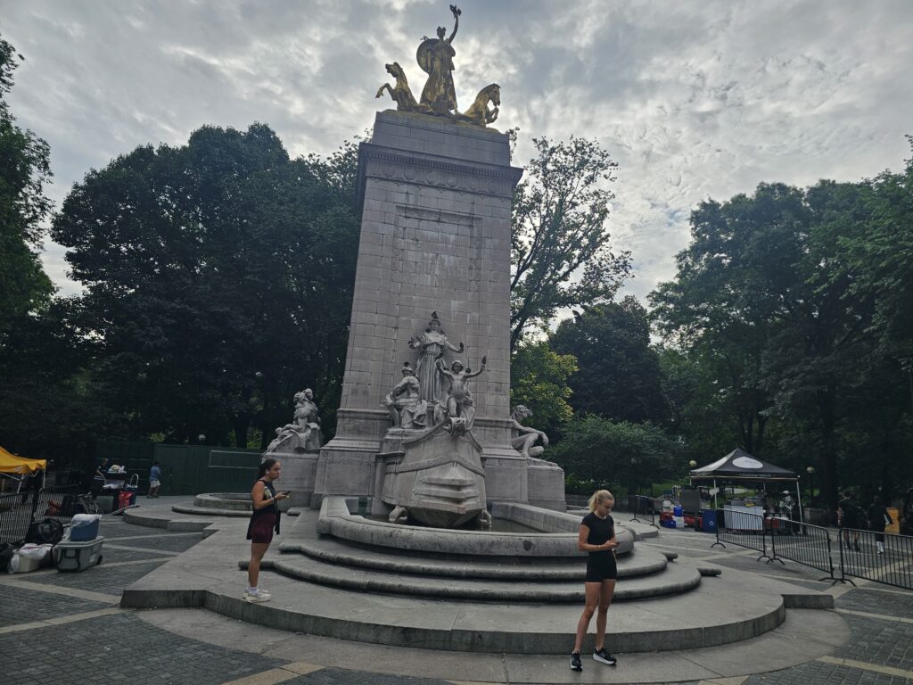Detailed view of the USS Maine National Monument sculpture and marble pedestal at Columbus Circle