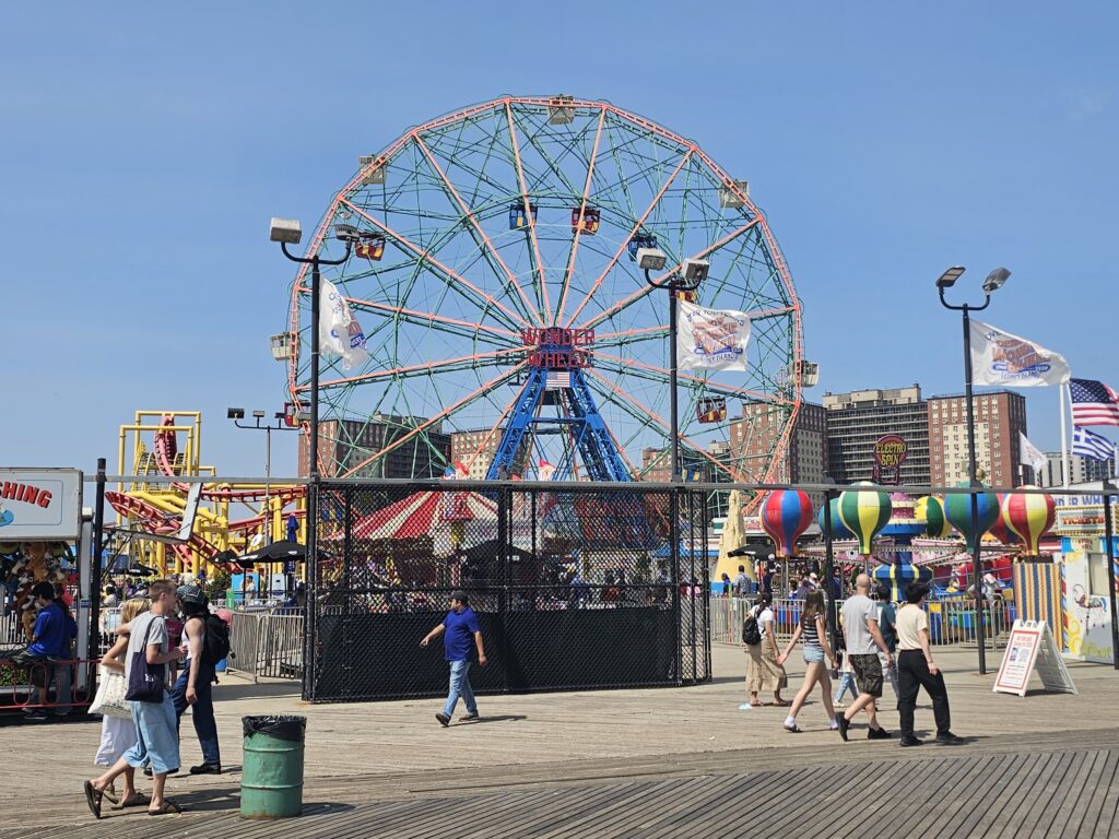 Deno's Wonder Wheel and colorful amusement rides on Coney Island boardwalk