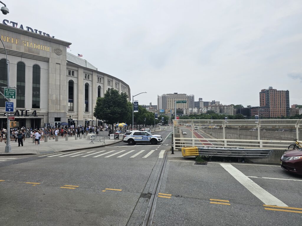 Yankee Stadium street view on game day with NYPD car