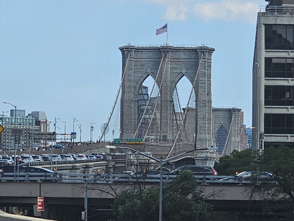 Brooklyn Bridge suspension towers with New York City skyline