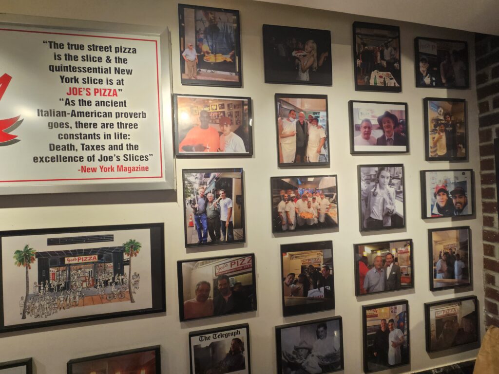 Joe's Pizza Wall of Fame with celebrity photos and New York Magazine feature