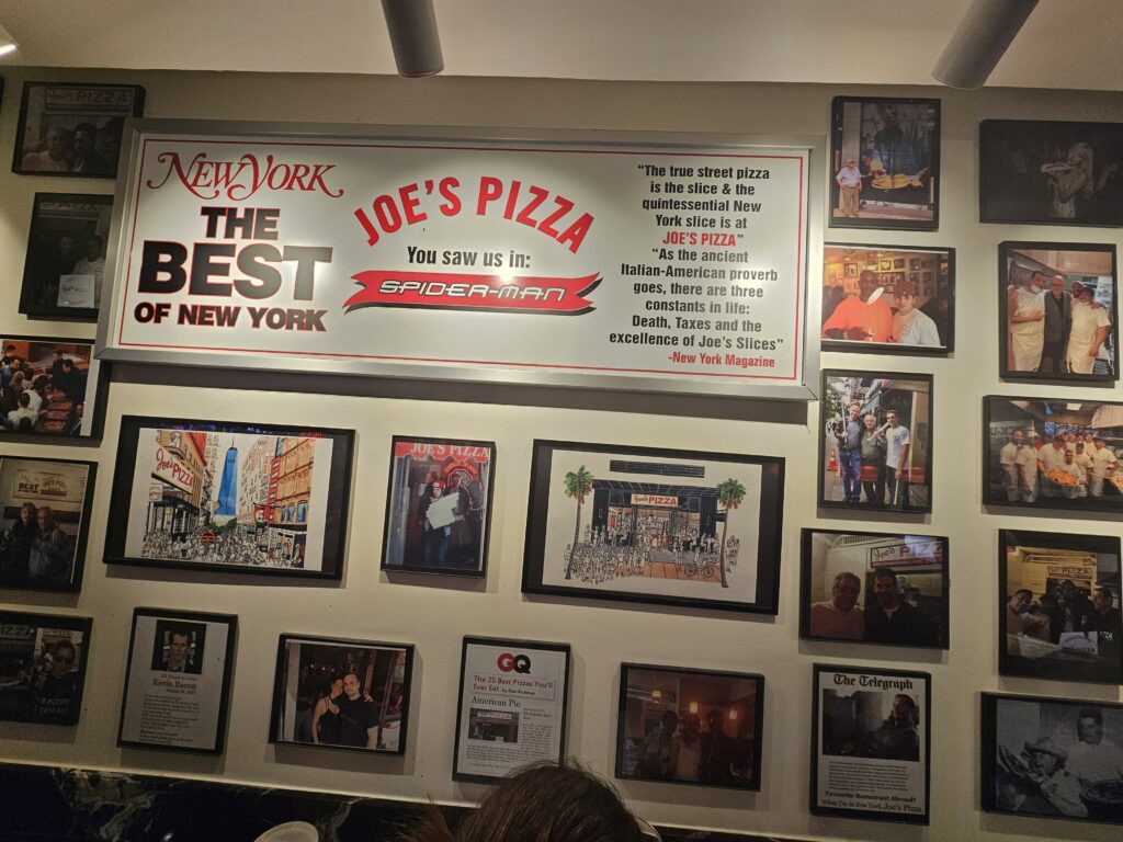 Joe's Pizza Best of New York and Spider-Man wall plaque inside the Midtown store