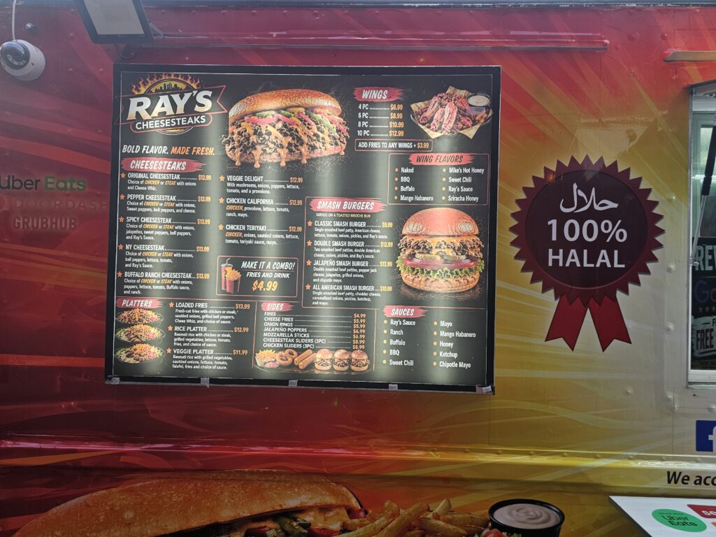 Ray's Cheesesteaks halal menu board with prices in Astoria