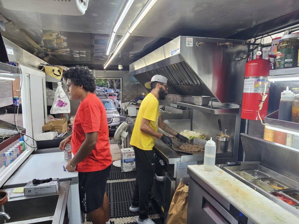 Chef grilling fresh ribeye steak for halal cheesesteak