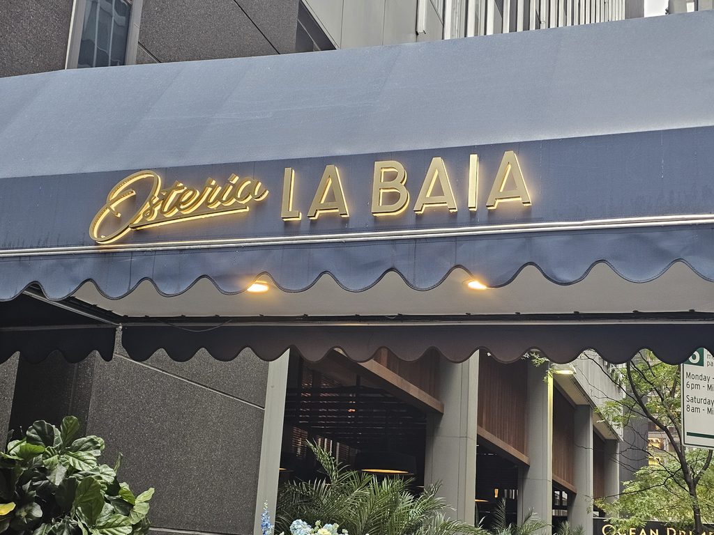 Osteria La Baia NYC stylish interior with blue seating and marble details