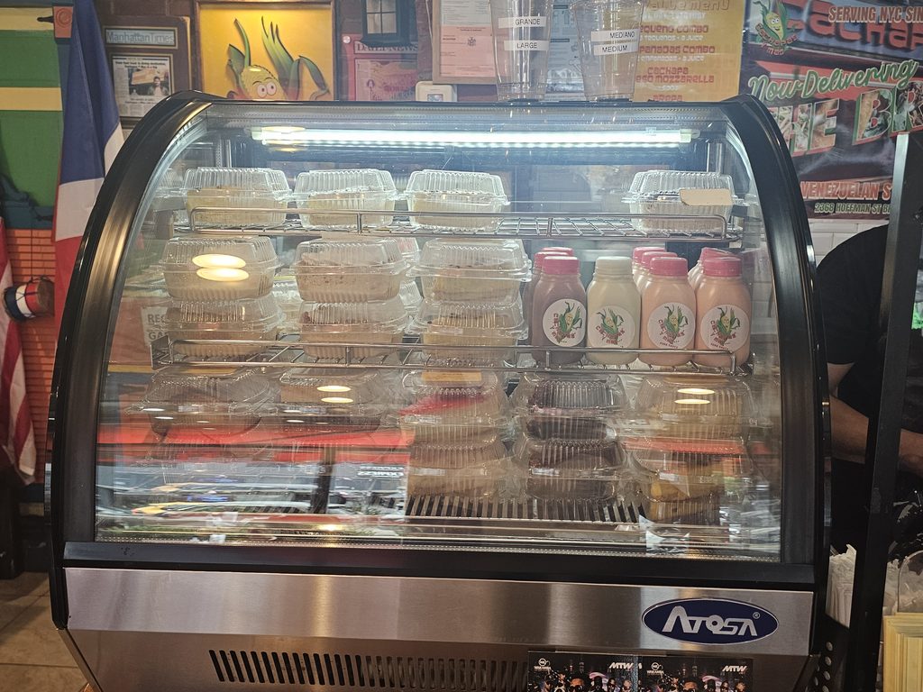 Bakery display case with Venezuelan pastries and desserts at Cachapas y Mas