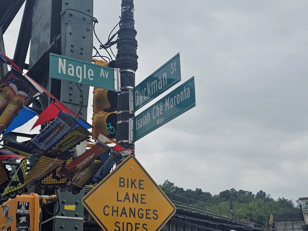 Dyckman Street and Nagle Avenue street sign near Cachapas y Mas in Inwood