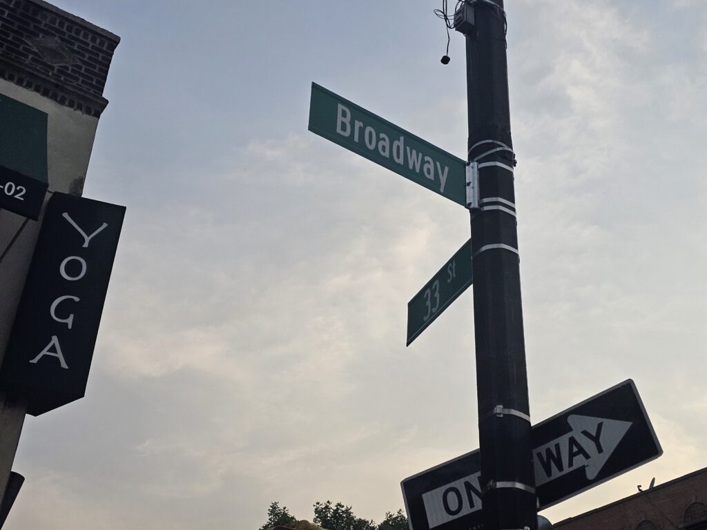 Broadway and 33rd Street sign near Junko Sushi and Yoga Agora