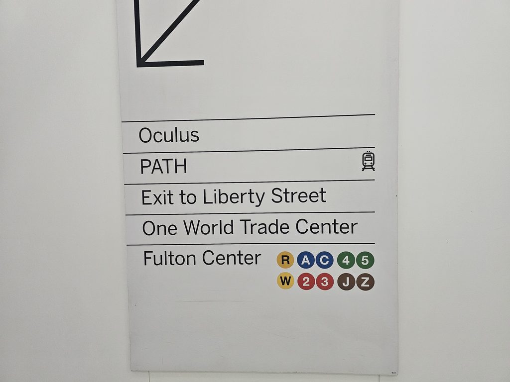 Wayfinding sign inside the Oculus World Trade Center showing PATH and subway connections