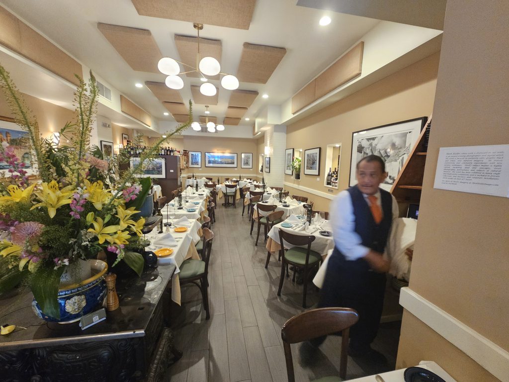 Server at La Terra Midtown East attending to the dining room