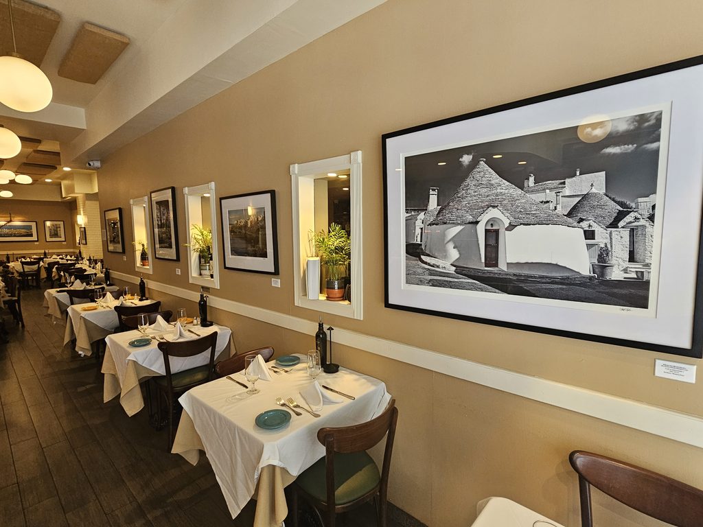 Framed photo of Polignano a Mare, Puglia, displayed inside La Terra Midtown East