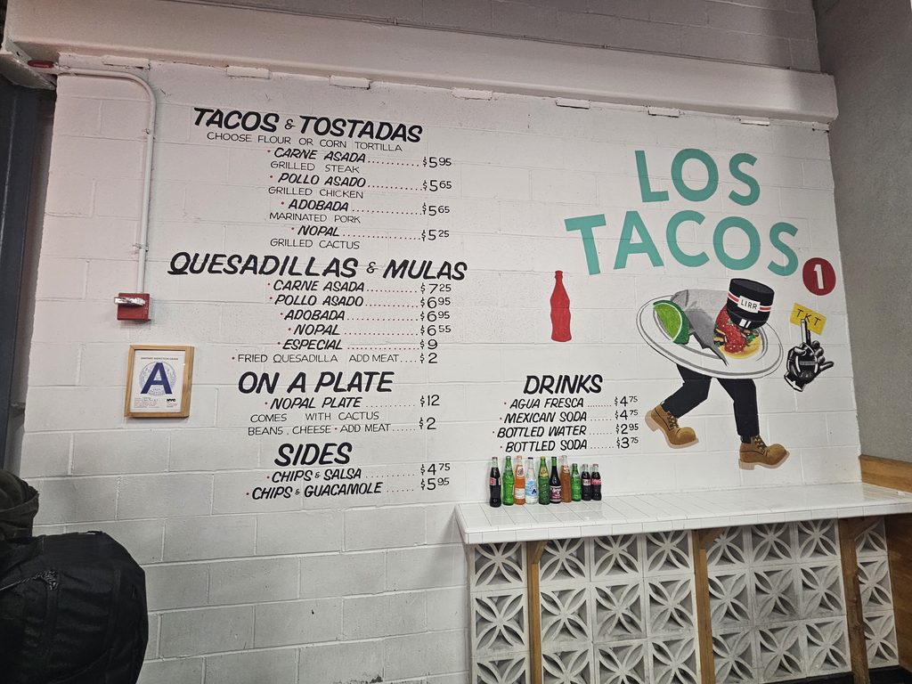 Los Tacos No.1 menu mural with mascot near Madison Square Garden
