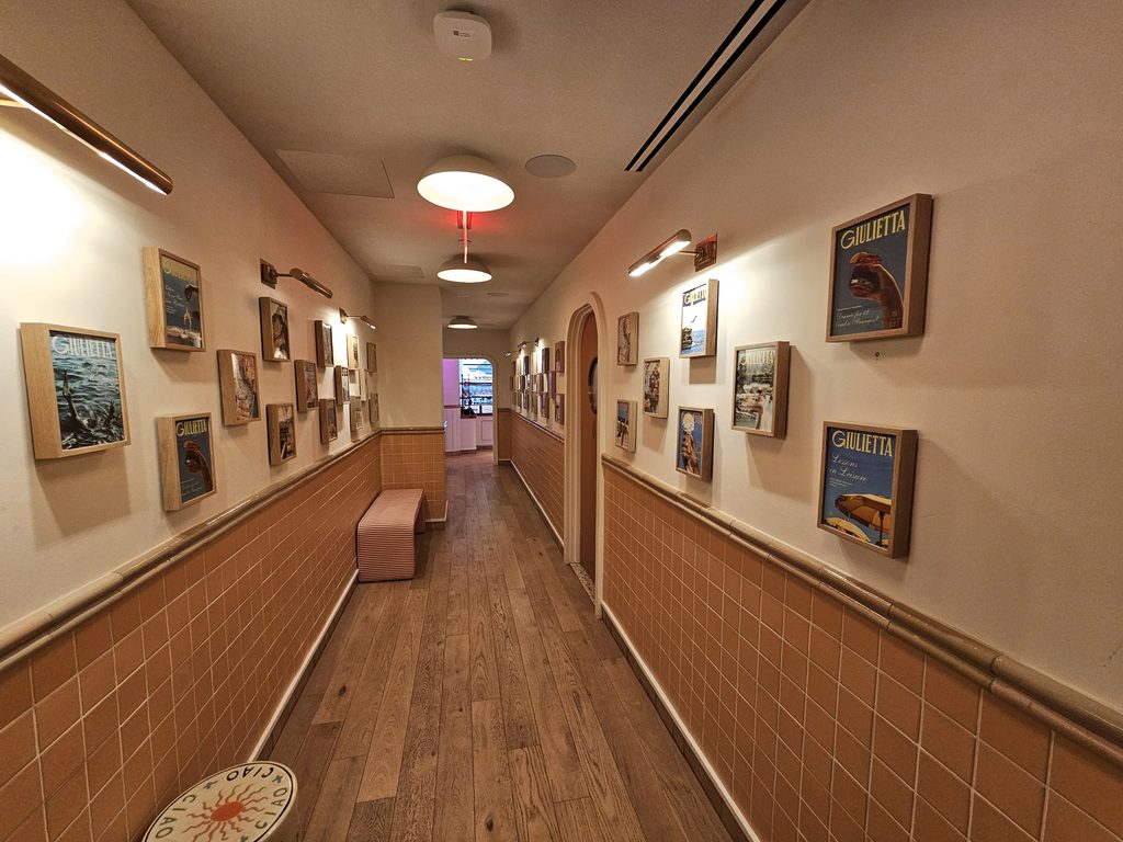 Giulietta NYC hallway with artwork and Mediterranean-inspired decor