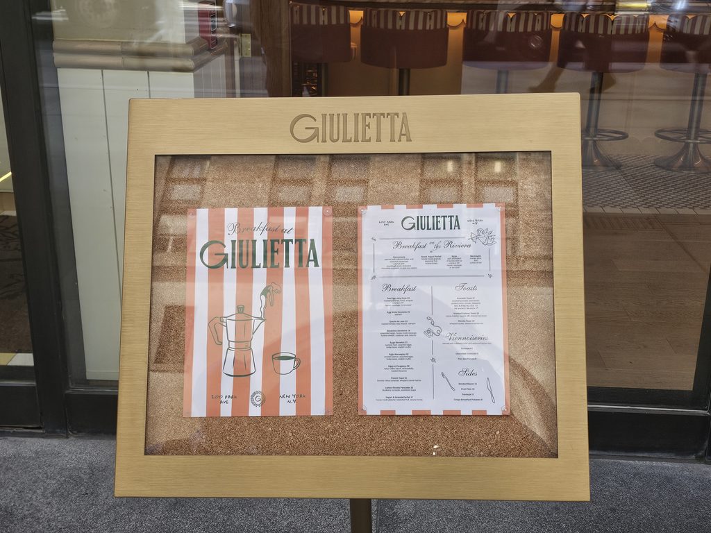 Giulietta NYC menu display at the restaurant entrance