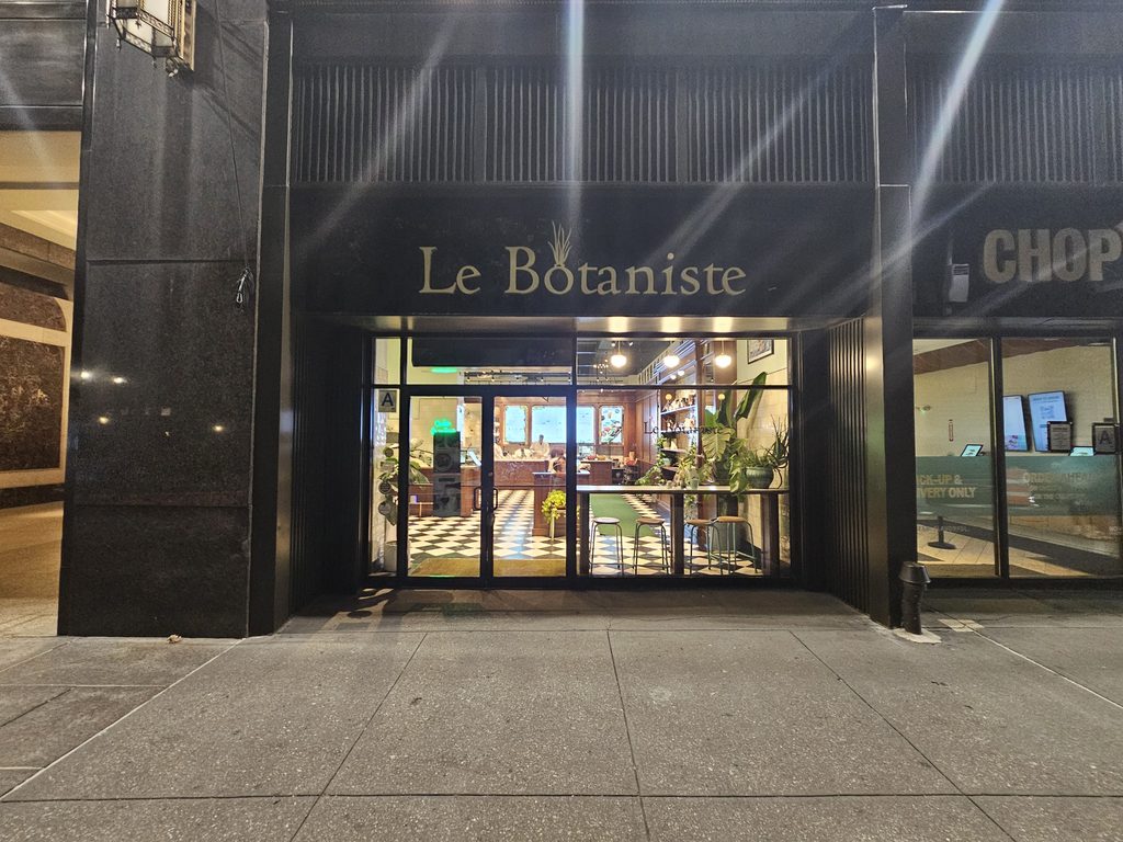 Le Botaniste Bryant Park storefront sign above the glass entrance at night