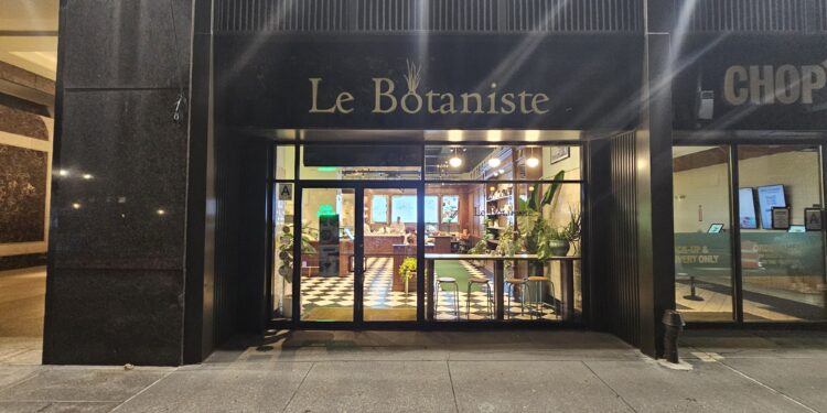Le Botaniste Bryant Park storefront sign above the glass entrance at night