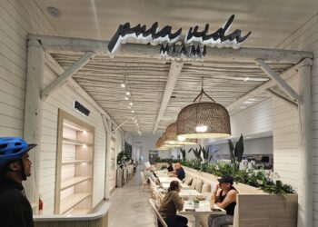 Pura Vida Miami NYC storefront sign glowing above the dining room entrance