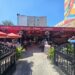 Harlem Tavern NYC entrance patio with red awnings and outdoor seating