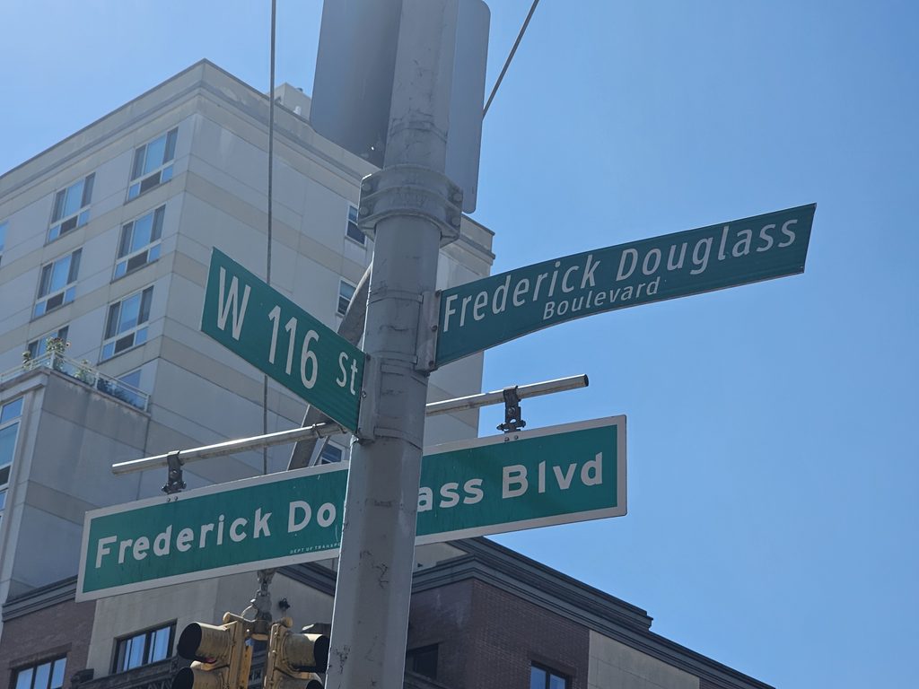Frederick Douglass Boulevard and West 116th Street sign near Harlem Tavern NYC
