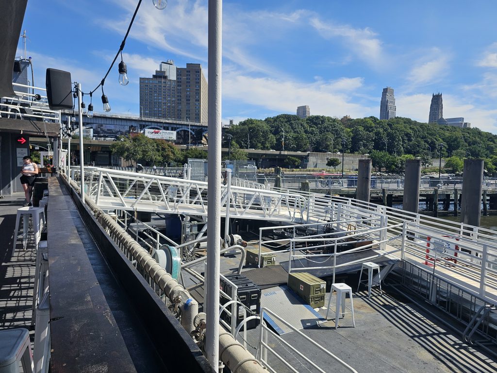 Gangway connecting Baylander Steel Beach to the pier with the New York City skyline in the background