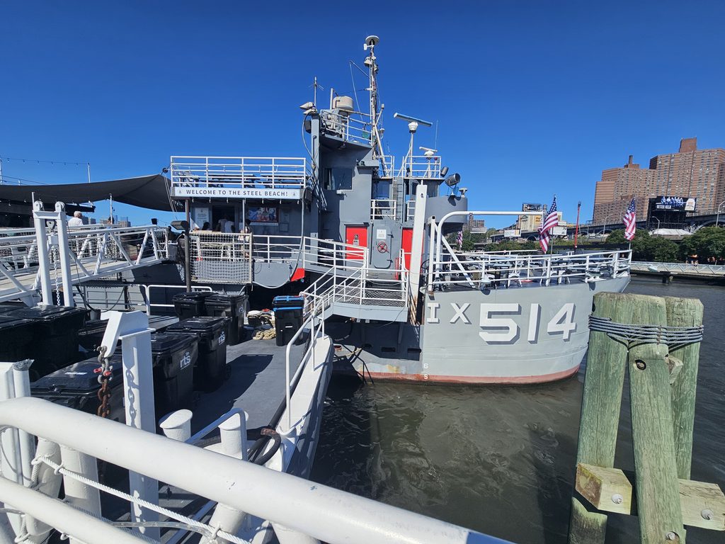 Baylander Steel Beach ship bow marked IX-514, docked at West Harlem Piers