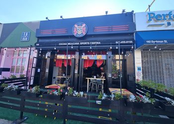 El Jefe Sports Cantina storefront on Dyckman Street with sugar skull logo and outdoor patio