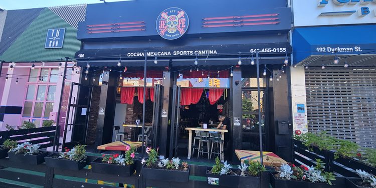 El Jefe Sports Cantina storefront on Dyckman Street with sugar skull logo and outdoor patio