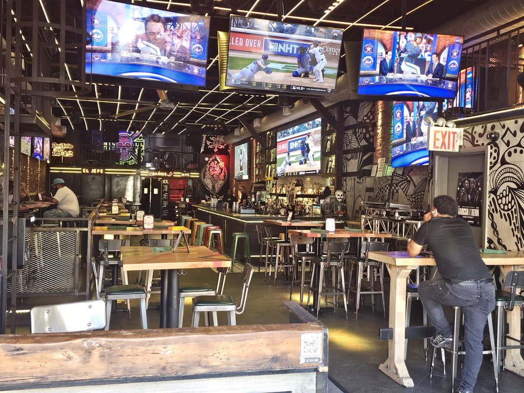 Interior of El Jefe Sports Cantina with multiple TV screens showing live sports games