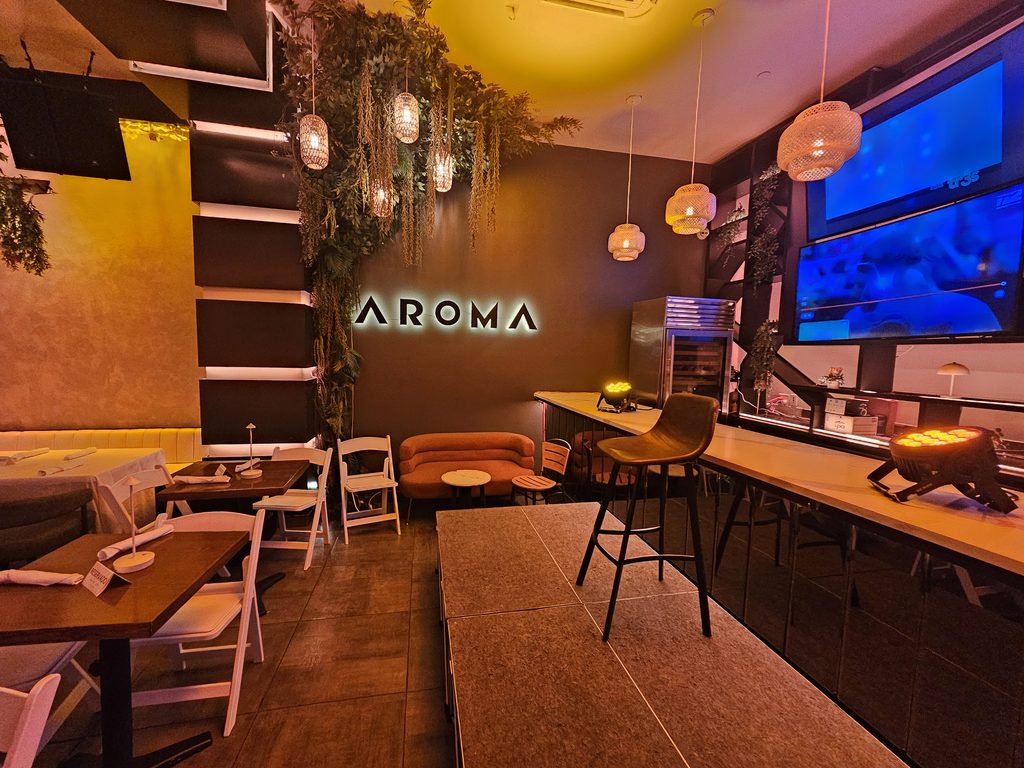 Aroma Restaurant Bar illuminated sign with pendant lighting and small stage