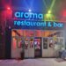Aroma Restaurant Bar neon storefront sign on Broadway in the Bronx
