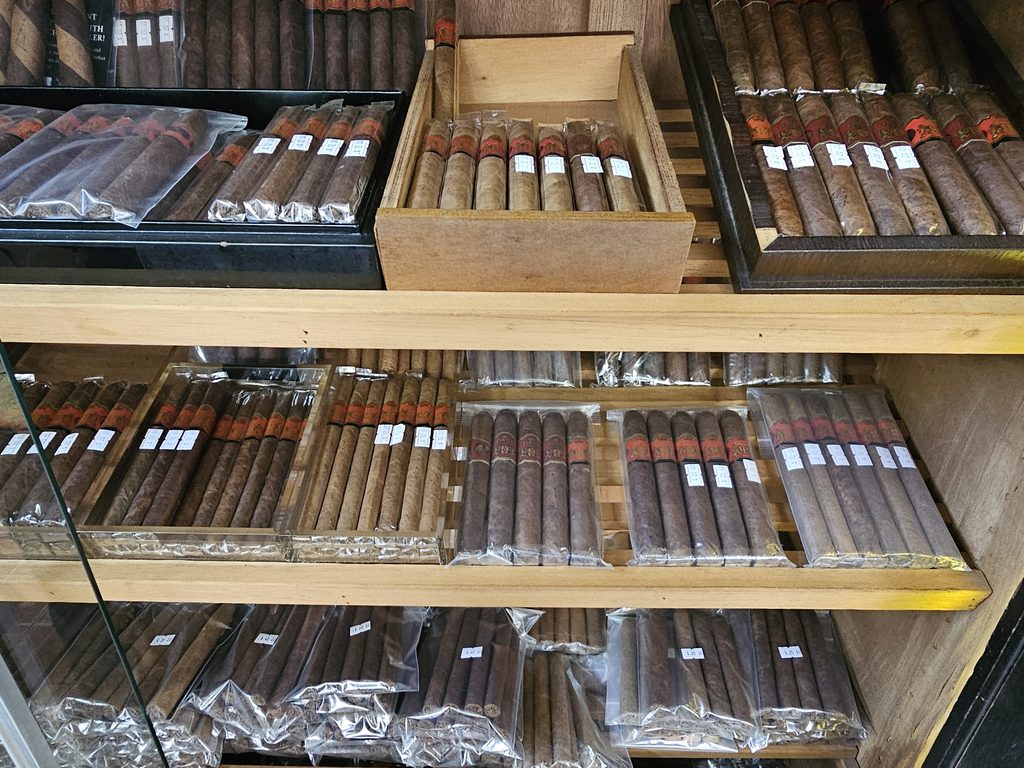 Bundles and boxes of hand-rolled cigars stocked inside Portes Cigars Inwood