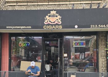 Portes Cigars NYC storefront with black awning on Broadway in Inwood, Manhattan