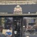 Portes Cigars NYC storefront with black awning on Broadway in Inwood, Manhattan