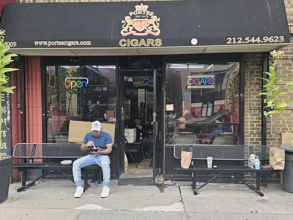 Portes Cigars NYC storefront with black awning on Broadway in Inwood, Manhattan