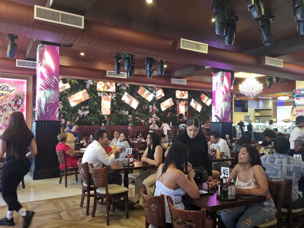 La Casa del Mofongo dining room packed with customers in Inwood NYC