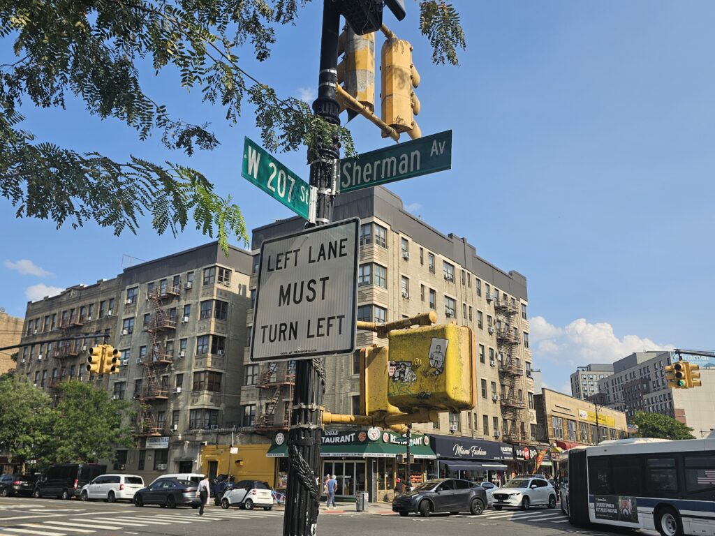 West 207th Street and Sherman Avenue street sign in Inwood Manhattan