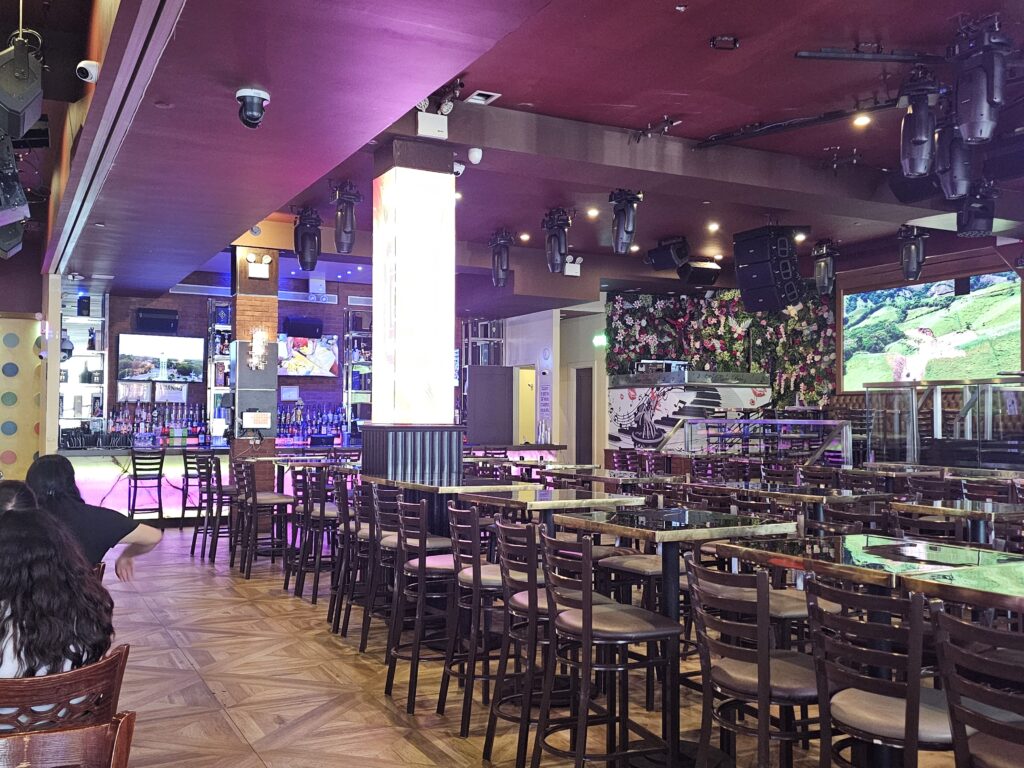 La Casa del Mofongo nightclub floor and DJ area lit in purple before the crowd arrives