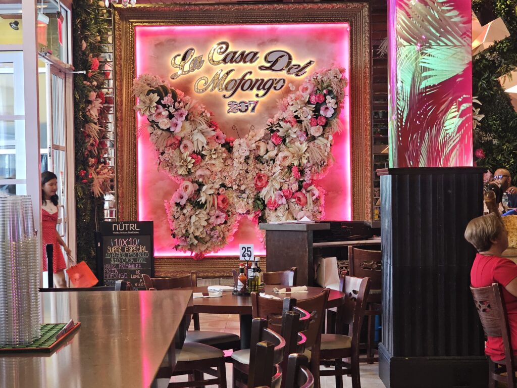 La Casa del Mofongo floral sign wall inside the Inwood Manhattan restaurant