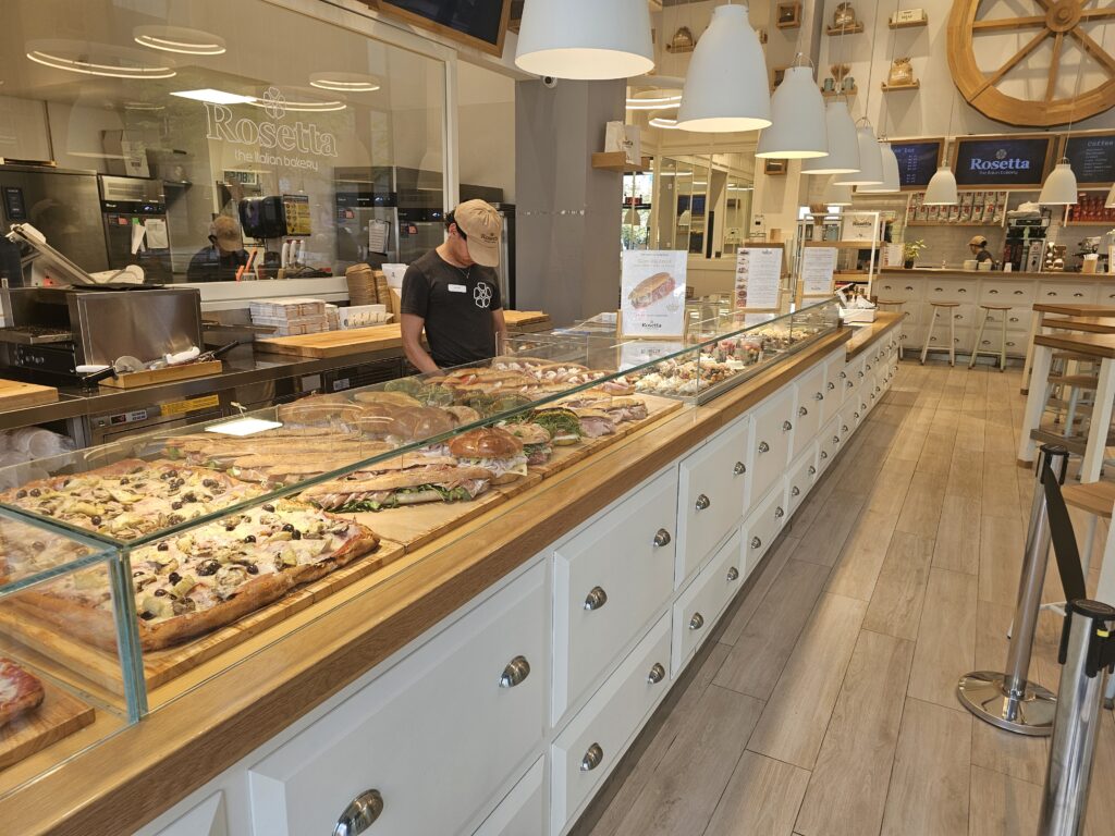Rosetta Bakery counter with fresh sandwiches and pizza on display