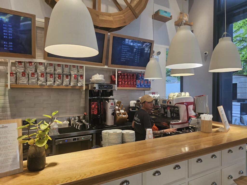 Rosetta Bakery barista preparing espresso at the coffee counter