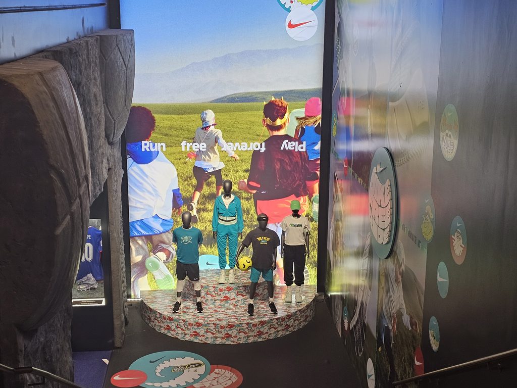 Kids apparel display with a Run free Play graphic inside the Nike flagship on Fifth Avenue