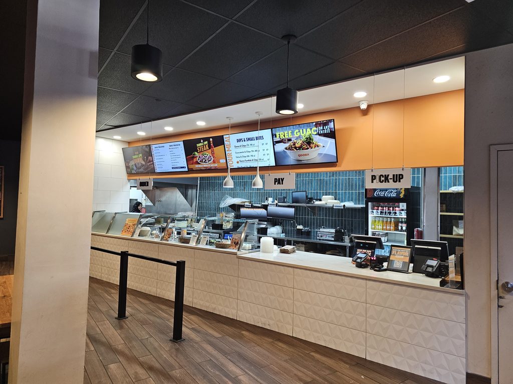 Ordering counter and pickup area inside QDOBA Fordham Road